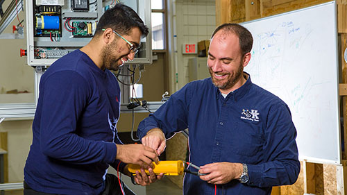 Two people work on equipment