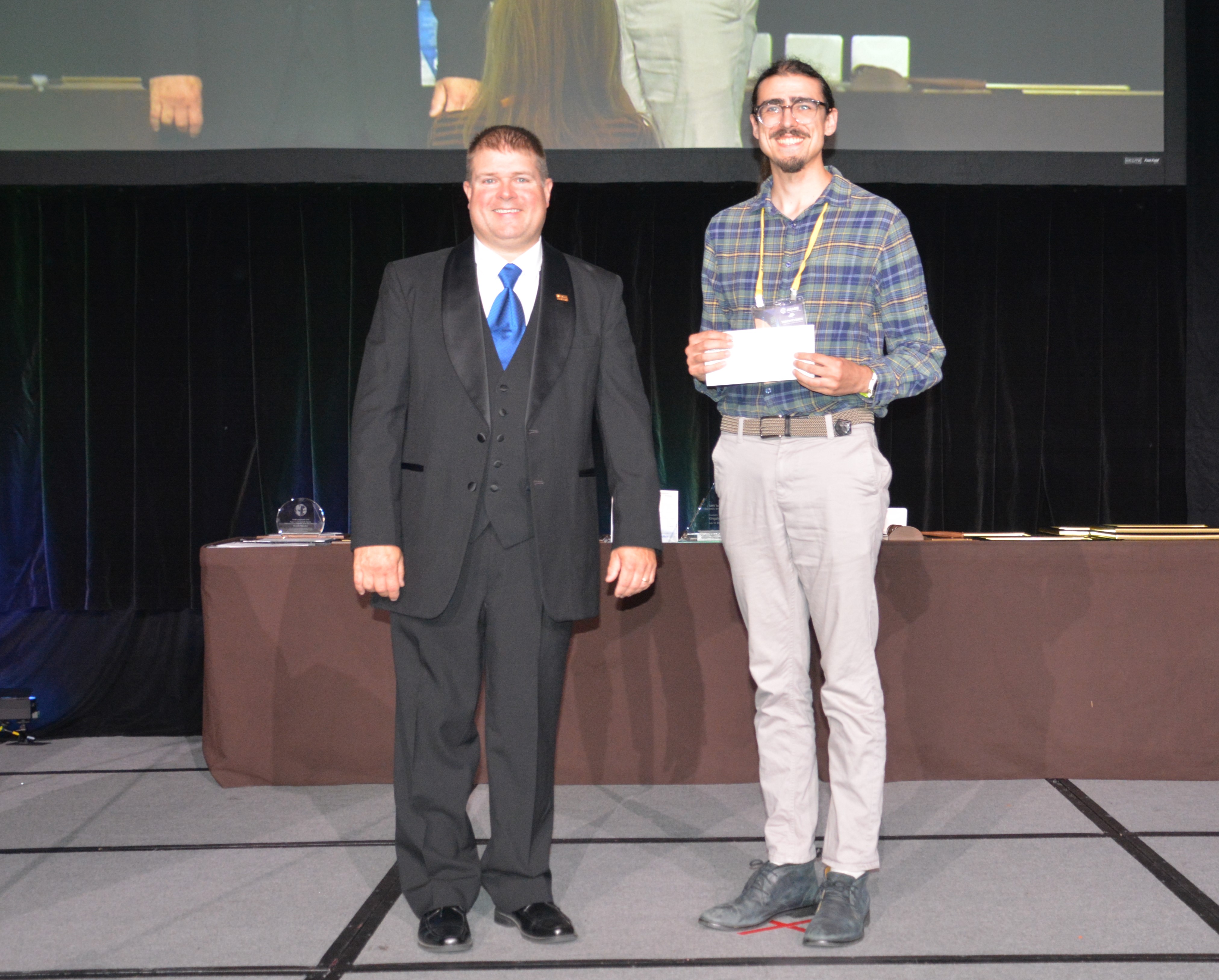 Ryan Sarhan accepting an award at the ASABE annual meeting 2025