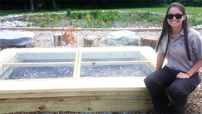 A worker sits at the Wolf Creek National Fish Hatchery Rain Garden