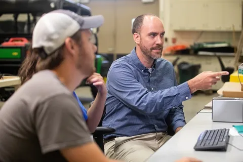 Dr. Mike Sama mentoring students in Machine Automation Systems
